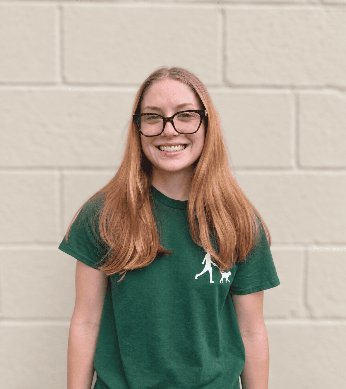 Bethesda Dog Walkers team member smiling in a green uniform shirt
